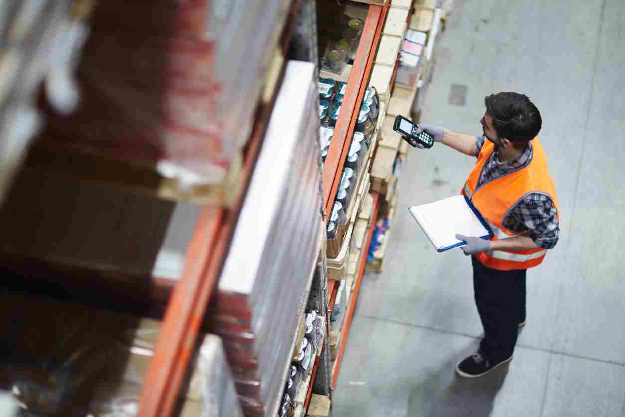 Man scanning barcodes in warehouse