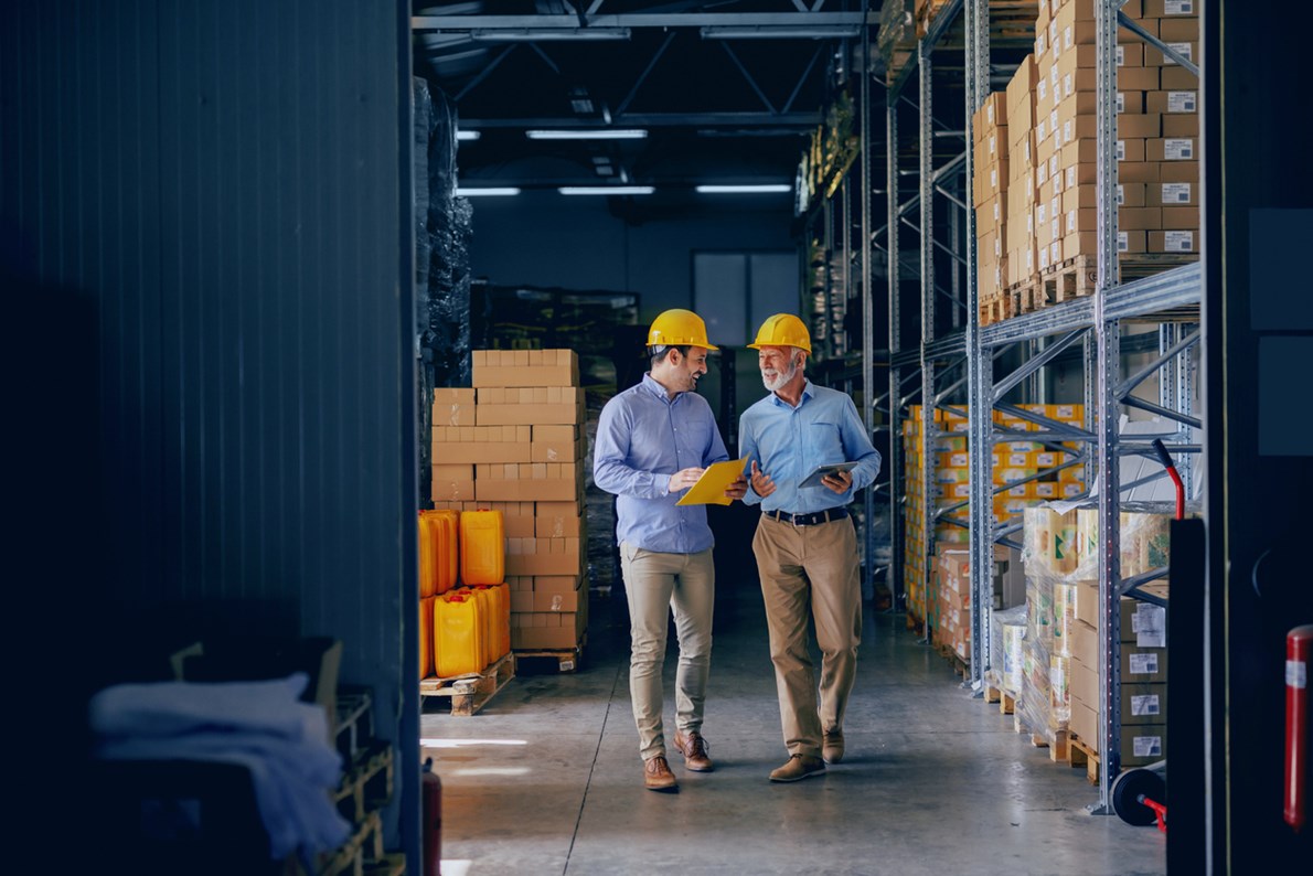 Two business men discussing how ERP inventory management has improved their customer relations.
